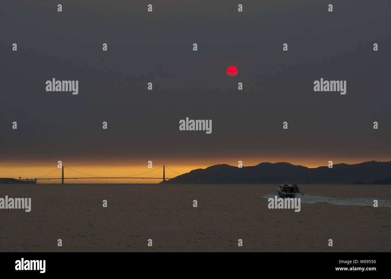 Smoke from Northern California wild fires leaves a dazzling display of the Golden Gate Bridge as the sun sinks into the smoke layer as seen from Berkeley, California on October 11, 2017. At least 17 major fires are roaring through wine country forcing tens of thousands of evacuations.     Photo by Terry Schmitt/UPI Stock Photo