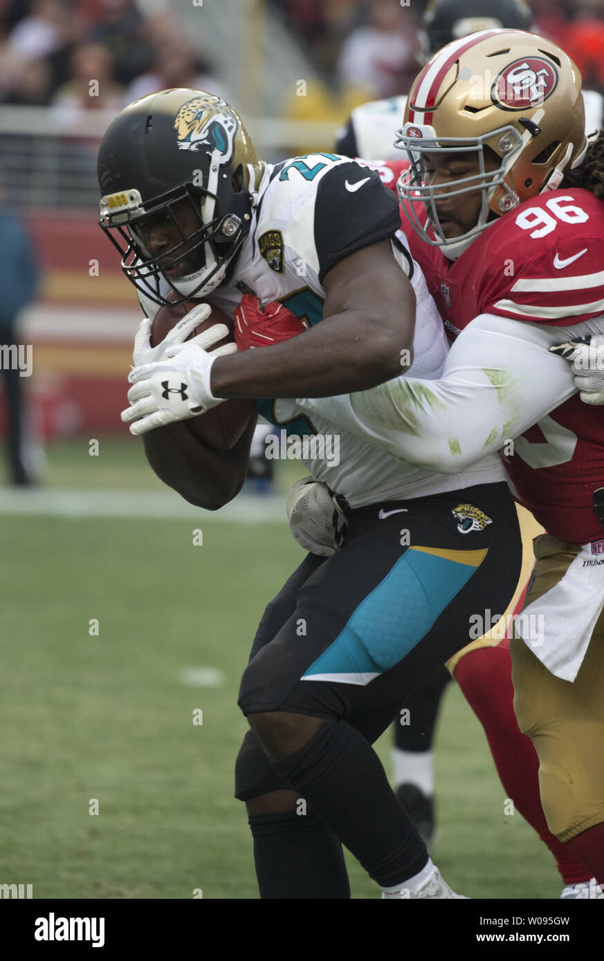 Jacksonville Jaguars Leonard Fournette (27) is tied up by San Francisco  49ers Sheldon Day (96) in the second quarter at Levi's Stadium in Santa  Clara, California, California on December 24, 2017. The