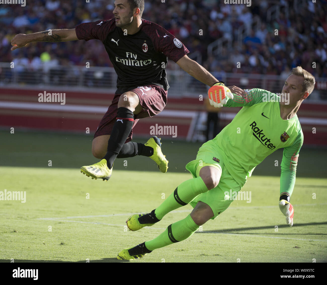 A.C. Milan's Patrick Cutrone (L) leaps over F.C. Barcelona goalie  Jasper Cillessen in the second half of International Champions Cup soccer at Levi's Stadium in Santa Clara, California on August 4, 2018.  Milan won 1-0.    Photo by Terry Schmitt/UPI Stock Photo