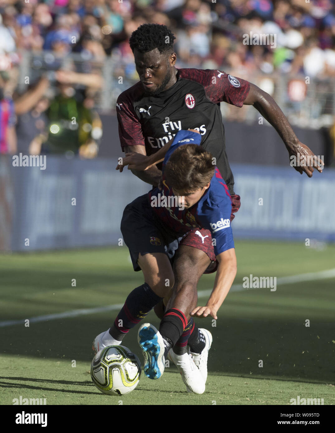 A.C. Milan's Franck Kessie (79) knocks down F.C. Barcelona's Ricky Puig in  the first half of International Champions Cup soccer at Levi's Stadium in  Santa Clara, California on August 4, 2018. Milan