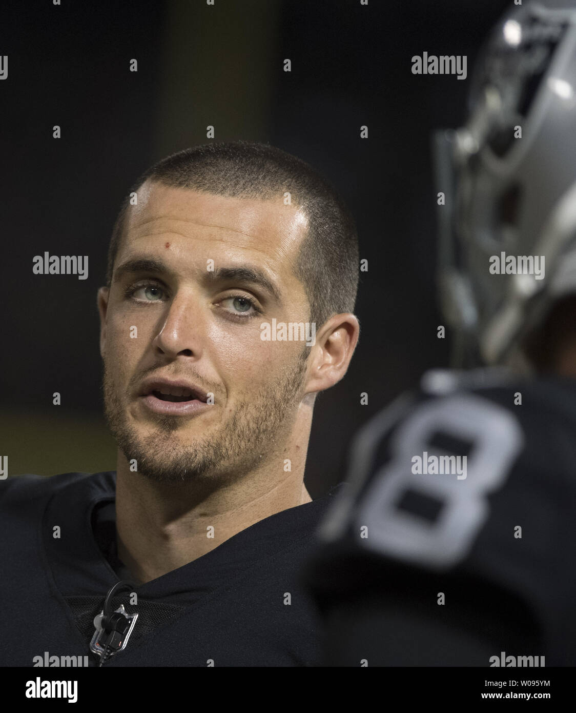 Oakland Raiders QB Derek Carr talks with QB Connor Cook in the second quarter against the Detroit Lions at the Coliseum in Oakland, California on August 10, 2018. The Raiders defeated the Lions 16-10.     Photo by Terry Schmitt/UPI Stock Photo