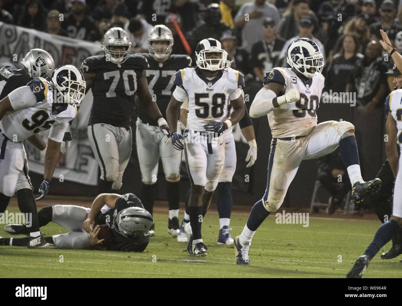 Los Angeles Rams Michael Brockers (90) celebrates sacking Oakland Raiders QB Derek Carr (L) for a loss of three yards in the third quarter at the Coliseum in Oakland, California on Monday, September 10, 2018. The Rams defeated the Raiders 33-13.       Photo by Terry Schmitt/UPI Stock Photo