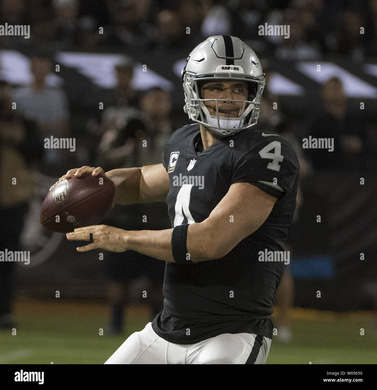 Oakland Raiders QB Derek Carr (4) throws against the Los Angeles Rams in the fourth quarter at the Coliseum in Oakland, California on Monday, September 10, 2018. The Rams defeated the Raiders 33-13.       Photo by Terry Schmitt/UPI Stock Photo