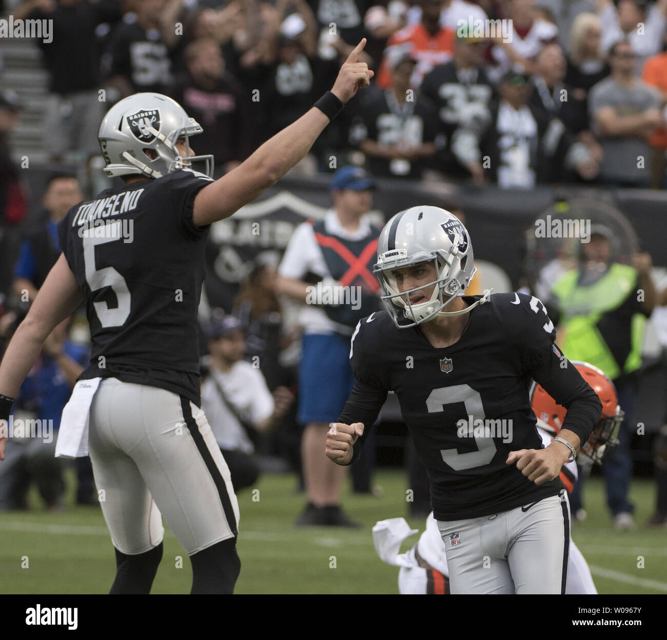 Oakland Raiders kicker Matt McGrane (3) celebrates as holder Johnny Townsend  raises a hand after kicking a 29 yrd field goal to defeate the Cleveland Browns in overtime at the Coliseum in Oakland, California on September 30, 2018. The Raiders won 45-42.     Photo by Terry Schmitt/UPI Stock Photo