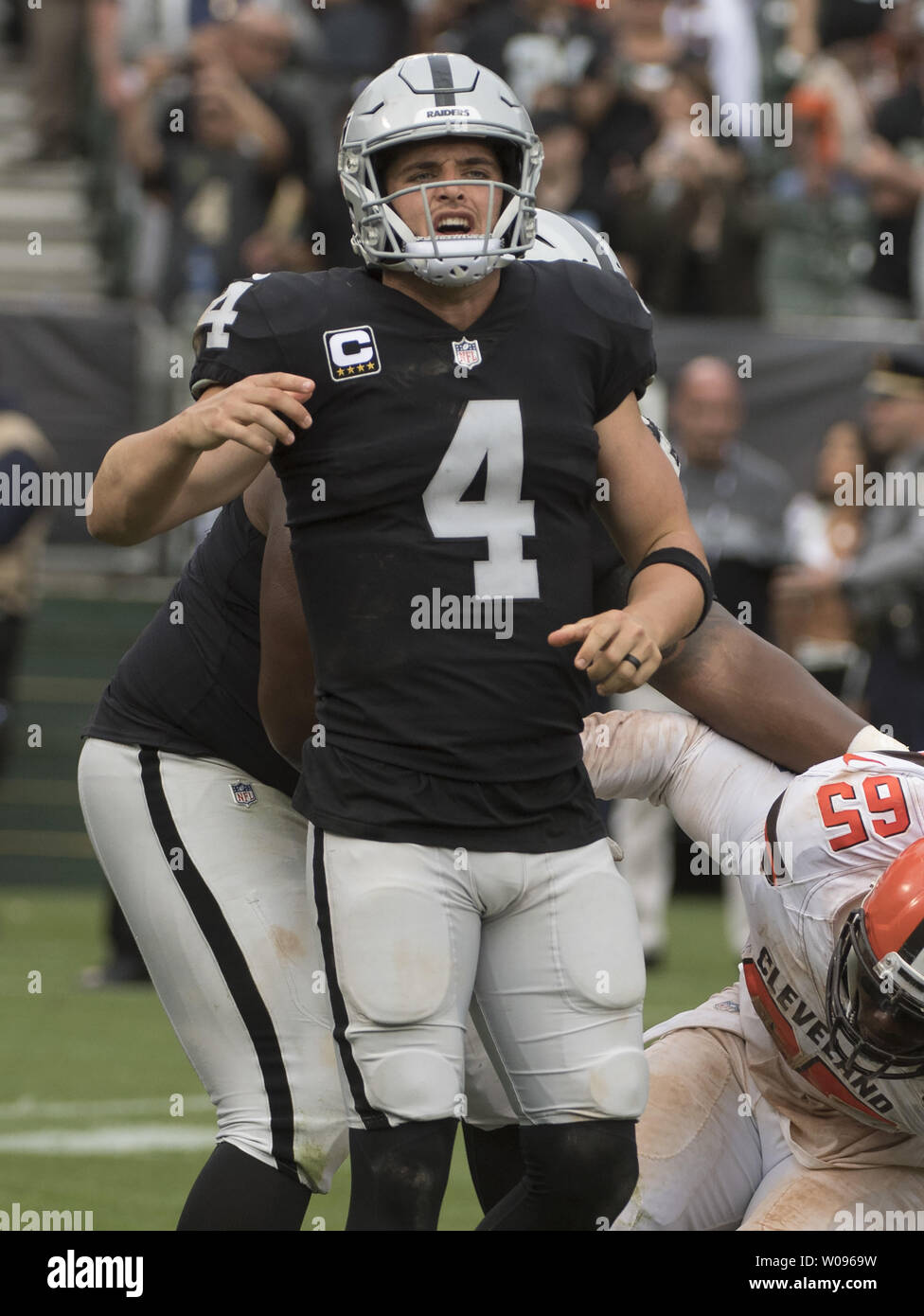 Oakland Raiders QB Derek Carr reacts to an incomplete pass and going out on downs in the fourth quarter against the Cleveland Browns at the Coliseum in Oakland, California on September 30, 2018. The Raiders defeated the Browns 45-42 in overtime.     Photo by Terry Schmitt/UPI Stock Photo