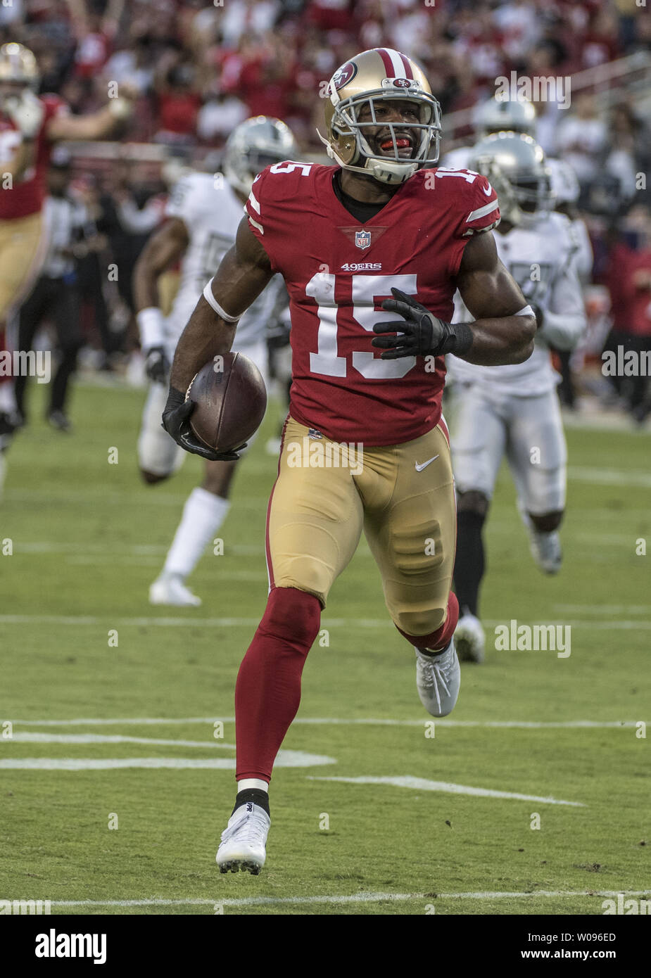 San Francisco 49ers wide receiver Pierre Garcon (15) romps toward the  endzone unmolested on a 24 yard pass from quarterback Nick Mullens (4) in  the first quarter against the Oakland Raiders at