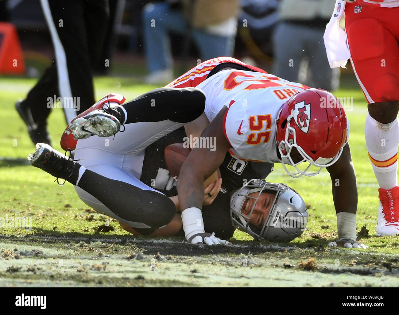 Kansas City Chiefs' linebacker Dee Ford (55) sacks Oakland Raiders quarterback Derek Carr for a loss of four yards in the first quarter at the Coliseum in Oakland, California on December 2, 2018. The Chiefs defeated the Raiders 40-33.    Photo by Terry Schmitt/UPI Stock Photo