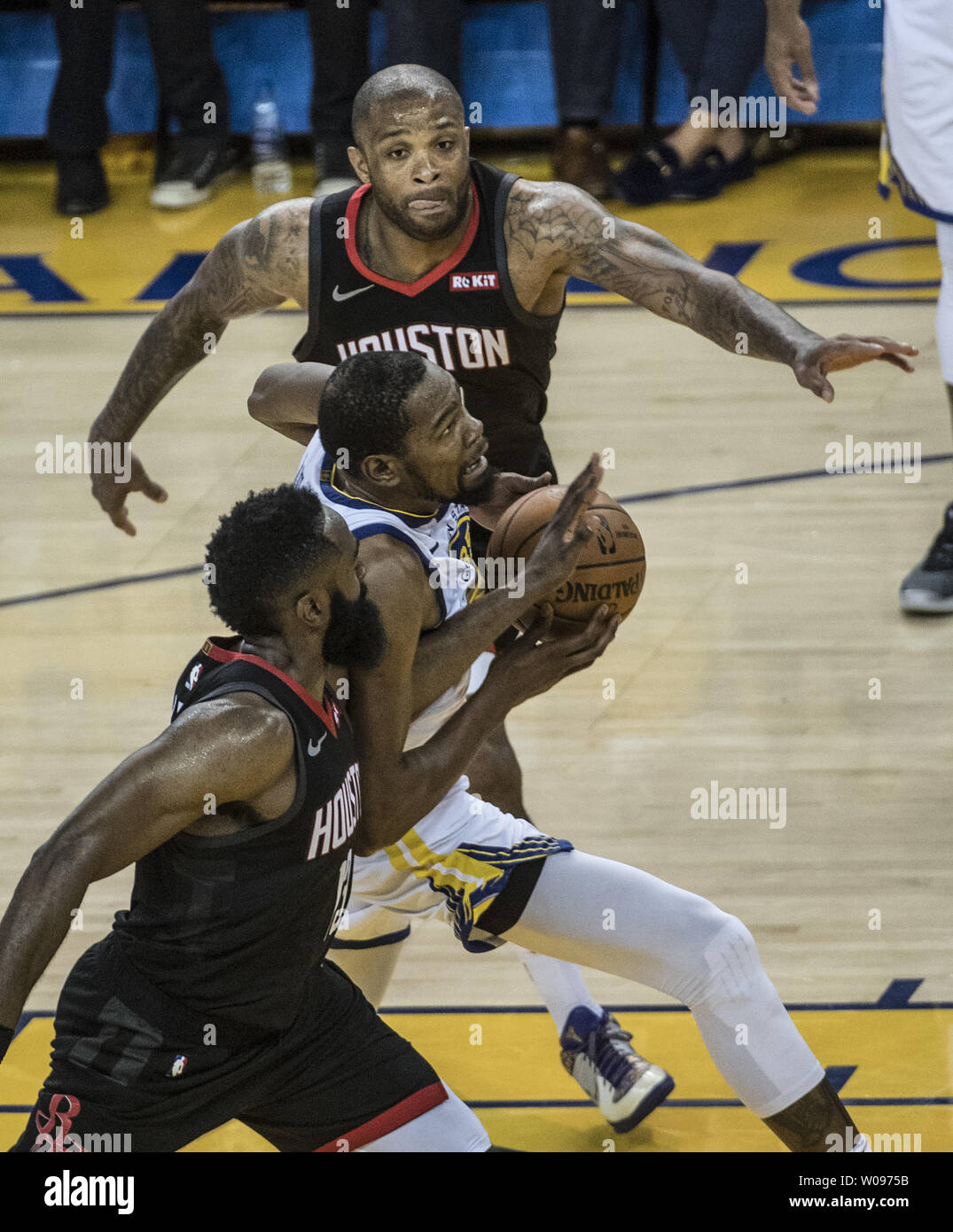Golden State Warriors Forward Kevin Durant C Drives Between Houston Rockets Guard James Harden And Forward Pj Tucker In Game One Of The Western Conference Semi Finals Of Nba Playoffs At Oracle Arena