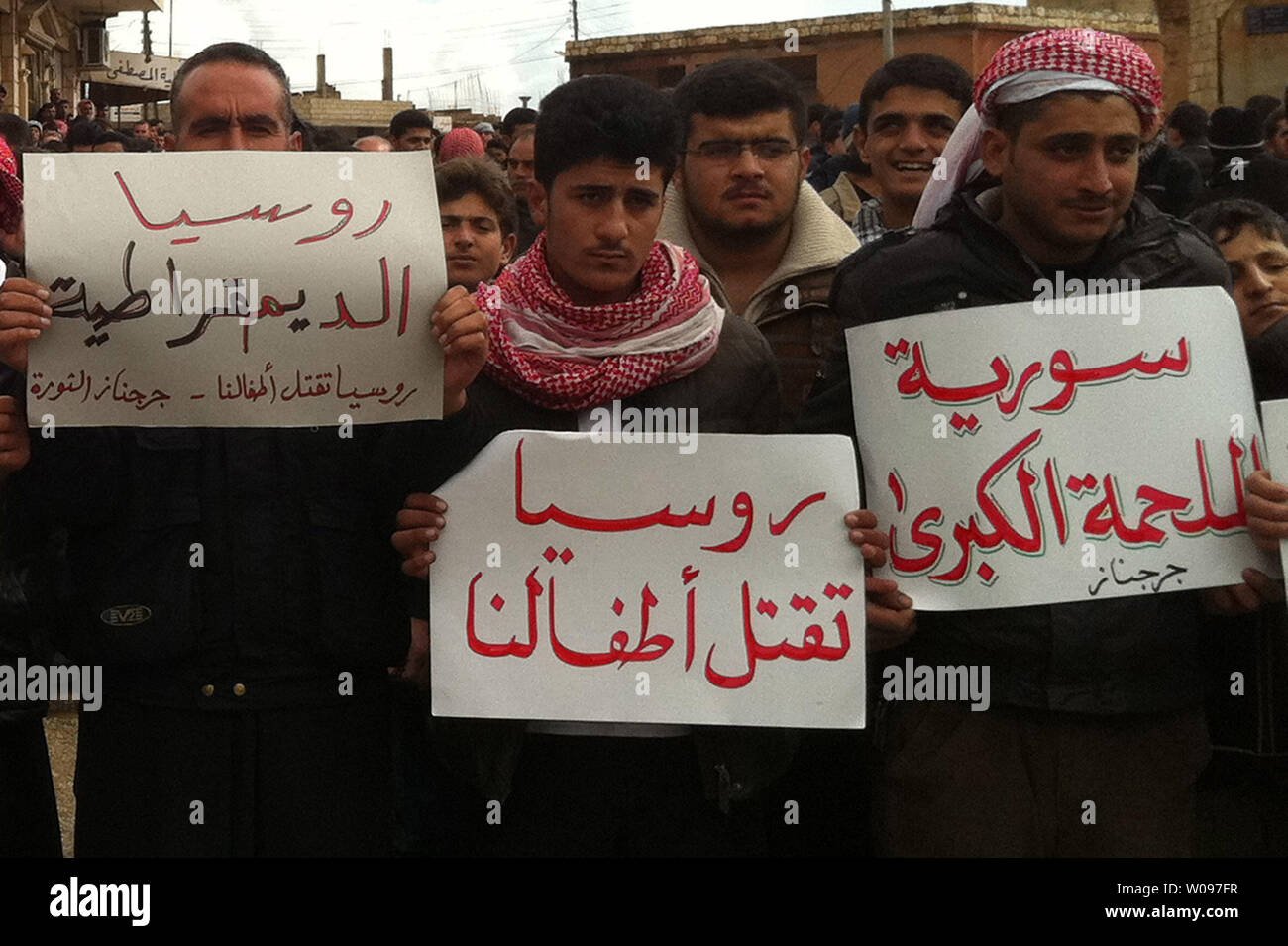 Syrian protesters hold banners that read in Arabic (Russia kills our children)  during a protest against Syria's President Bashar al-Assad in Jrbanaz near Idlib in Syria on February 11, 2012.    UPI Stock Photo