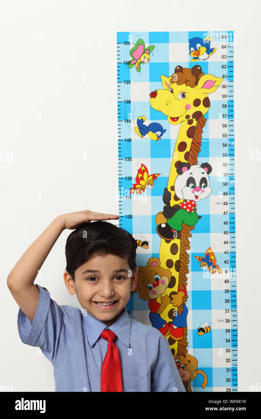 https://c8.alamy.com/comp/W0981R/portrait-of-an-indian-schoolboy-measuring-his-height-W0981R.jpg