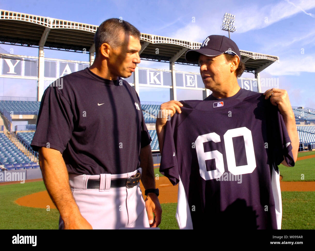 https://c8.alamy.com/comp/W099AR/new-york-yankees-manager-joe-girardi-l-presents-a-team-jersey-to-comedian-billy-crystal-after-crystal-signed-a-one-game-contract-with-the-team-at-legends-field-in-tampa-florida-on-march-12-2008-crystal-will-turn-60-on-march-14-and-it-was-his-birthday-wish-to-become-a-new-york-yankee-team-member-upi-photocathy-kapulka-W099AR.jpg