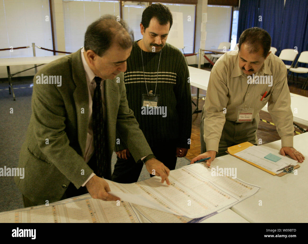 Tarik Abdullah (left), Nizar Ali (center) and Tahir Hussain (right) confer on the final day of local vote tabulation for the Iraq Out-of-Country Voting Program transitional national assembly election on Tuesday, Feb. 1, 2005 at Fraternal Order of Police Andrew Jackson Lodge No. 5 in Nashville, Tennessee.  Approximately 95% of the 3,700 Iraqi expatriates registered to vote in Nashville turned out for the election, according to a local spokesperson.  (UPI Photo/Billy Suratt) Stock Photo