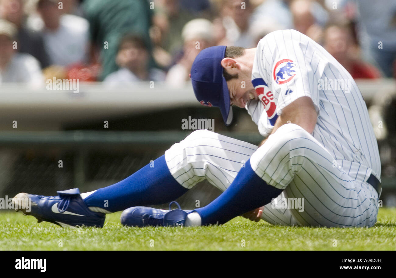 Chicago Cubs pitcher Mark Prior grimaces as he sits on the infield after  being hit on his pitching arm by a line drive off the bat of Colorado  Rockies outfielder Brad Hawpe