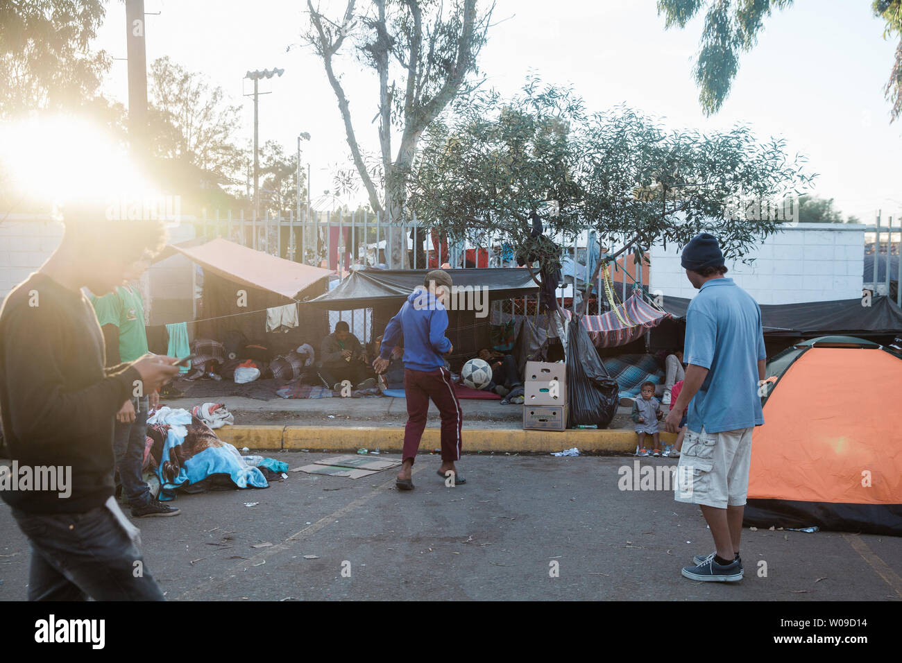 People play soccer to occupy the time in front of the makeshift migrant shelter at the Unidad Deportiva Benito Juarez in Tijuana, Mexico on November 26, 2018.   Photo by Ariana Drehsler/UPI Stock Photo