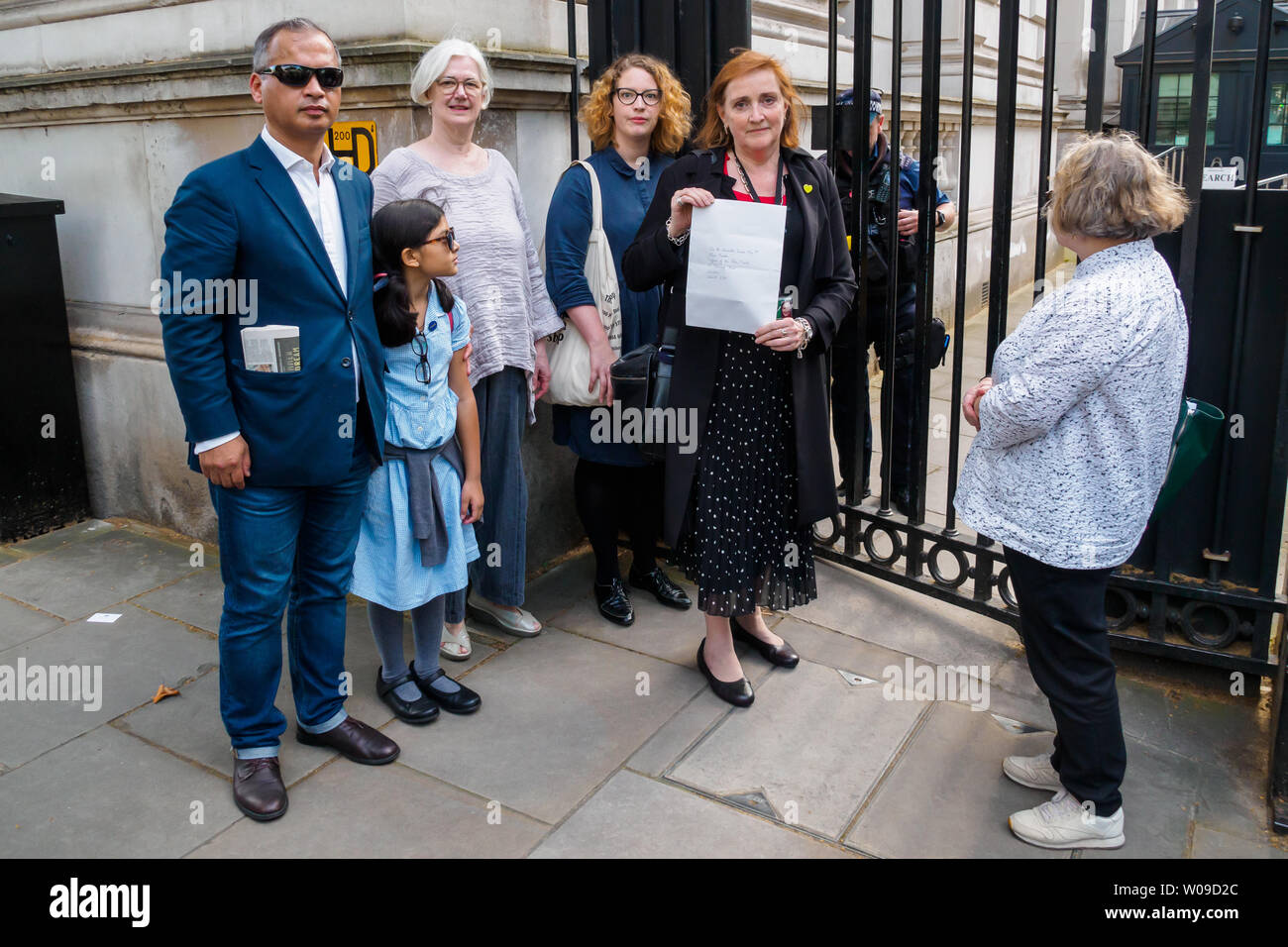 London, UK. 26th June 2019. . A delegation including CND Vice-Chair Carol Turner, Lindsey Germanb, Kensington Labour MP Emma Dent Coad and Murad Qureshi, chair of the Stop the War Coalition with a letter to Theresa May at the security gate to Downing St calling for no military action against Iran. They were all refused entry, including MP Emma Dent Coad who showed her parliamentary pass. She spoke to the rally and was followed by CND Vice-Chair Carol Turner and others. Peter Marshall/Alamy Live News Stock Photo