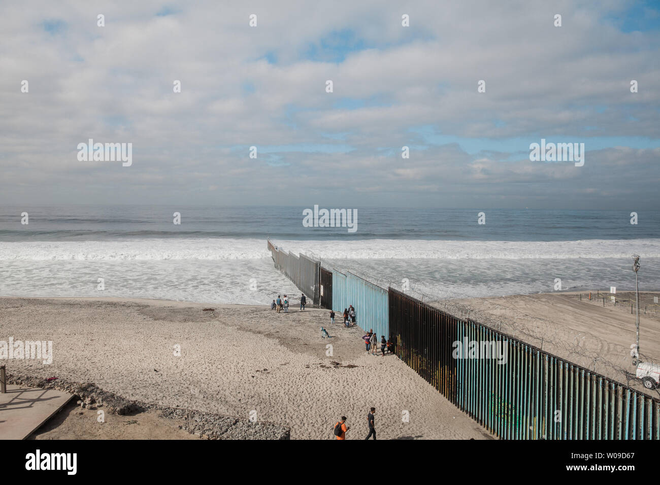 People stand on the beach on the Mexican side of the border fence at Playas de Tijuana with the U.S. to the right of the wall in Jijuana, Mexico on November 28, 2018.    Photo by Ariana Drehsler/UPI Stock Photo