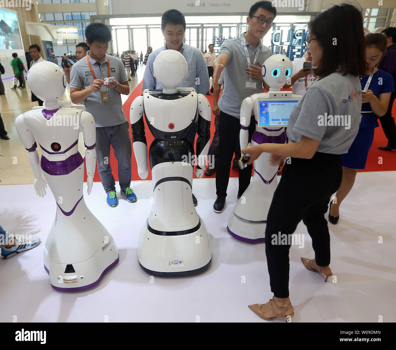 Chinese interact with robots on display during the World Intelligence Conference in Tianjin on June 30, 2017.  The Congress addressed the research and development of artificial intelligence emerging in daily life applications.       Photo by Stephen Shaver/UPI Stock Photo