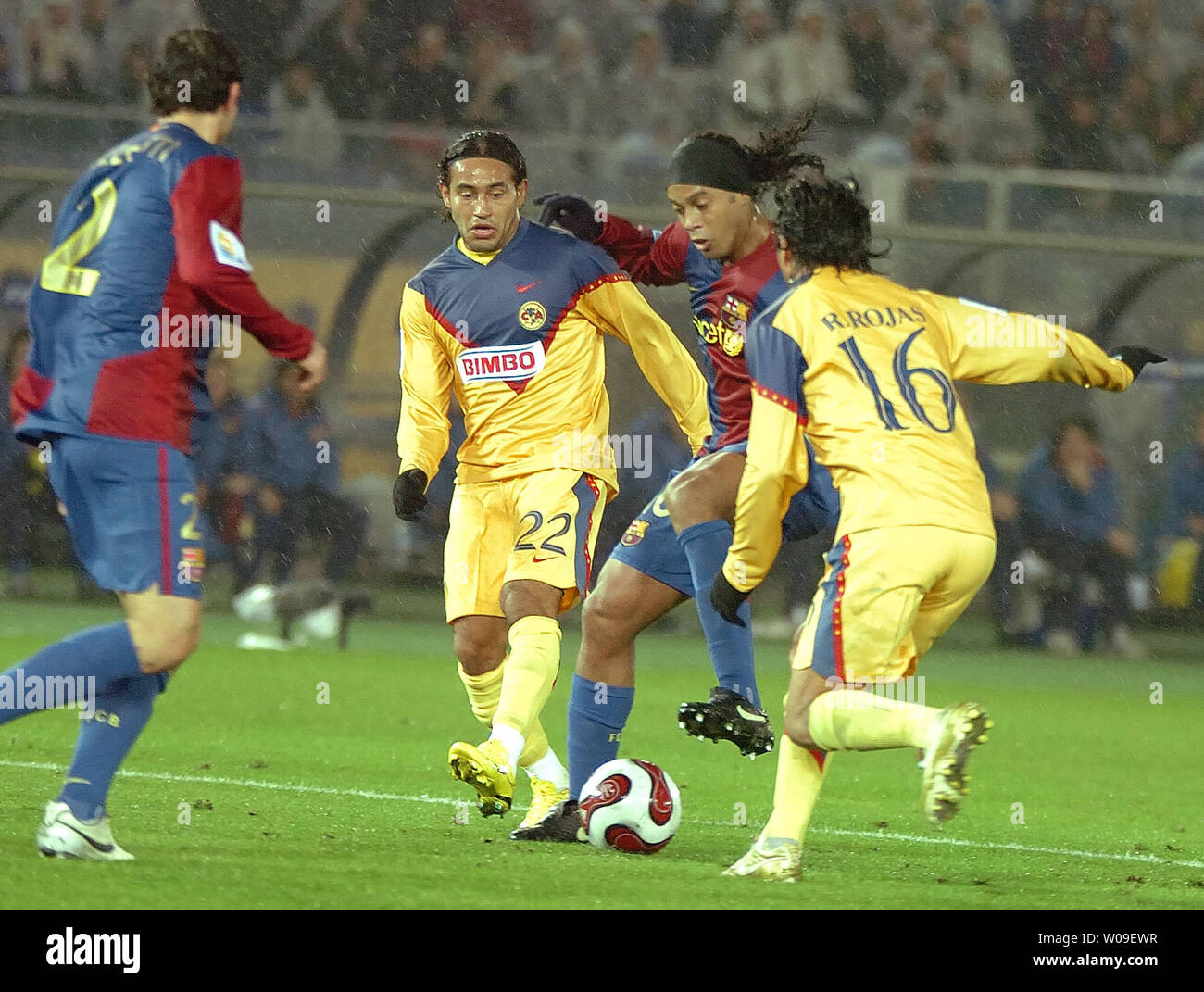 FC Barcelona's Ronaldinho dribbles the ball away from the defense in the second half of  the FIFA Club World Cup semifinal against Mexico's Club America at Yokohama's Nissan Stadium in Japan on December 14, 2006. FC Barcelona beat Club America 4-0. (UPI Photo/Keizo Mori) Stock Photo