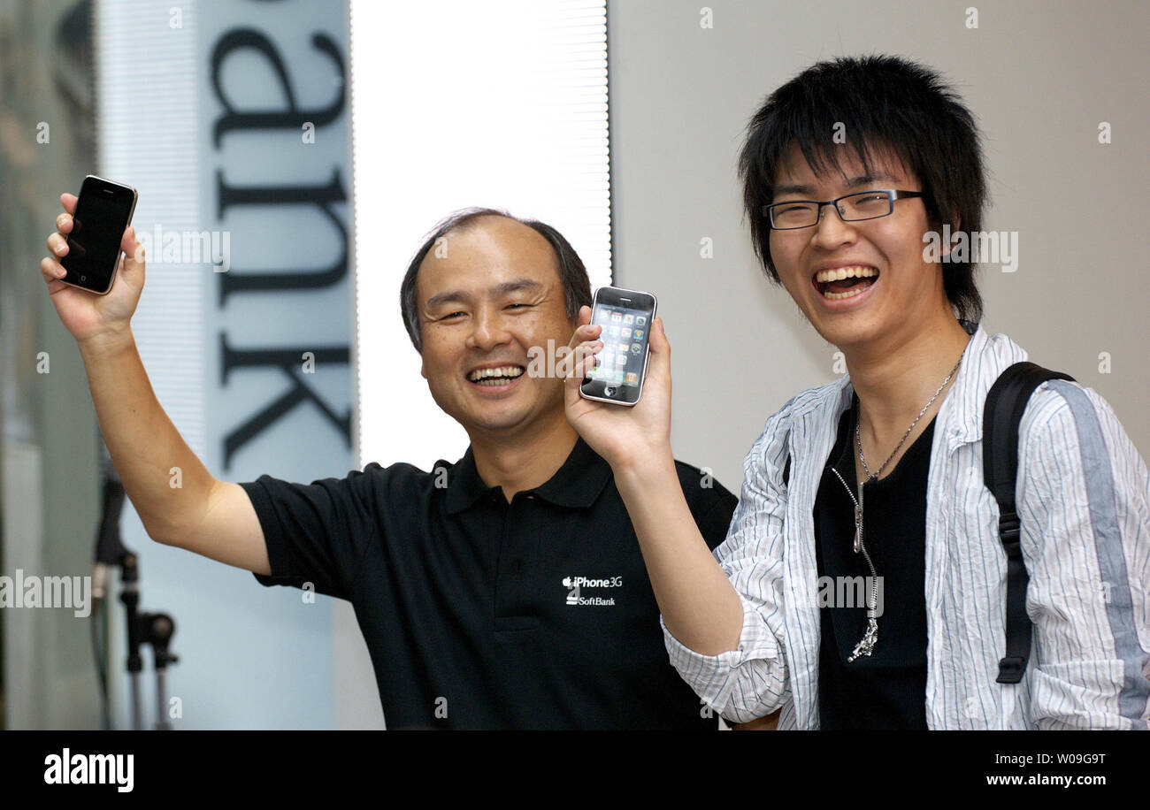 Masayoshi Son (L) of Softbank Mobile Corp., Chairman & CEO poses