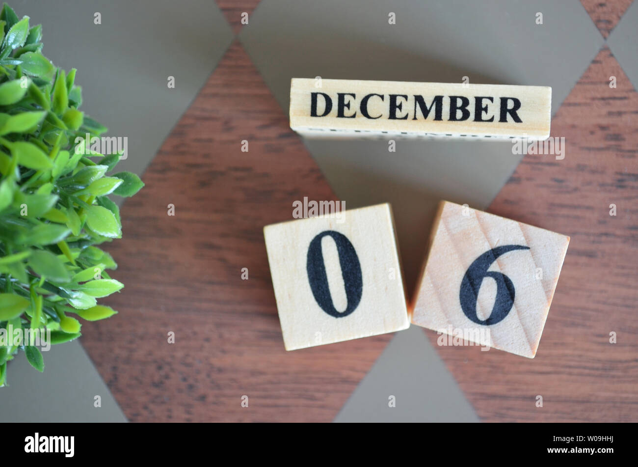 Date of December month with leaf on diamond pattern table for background. Stock Photo