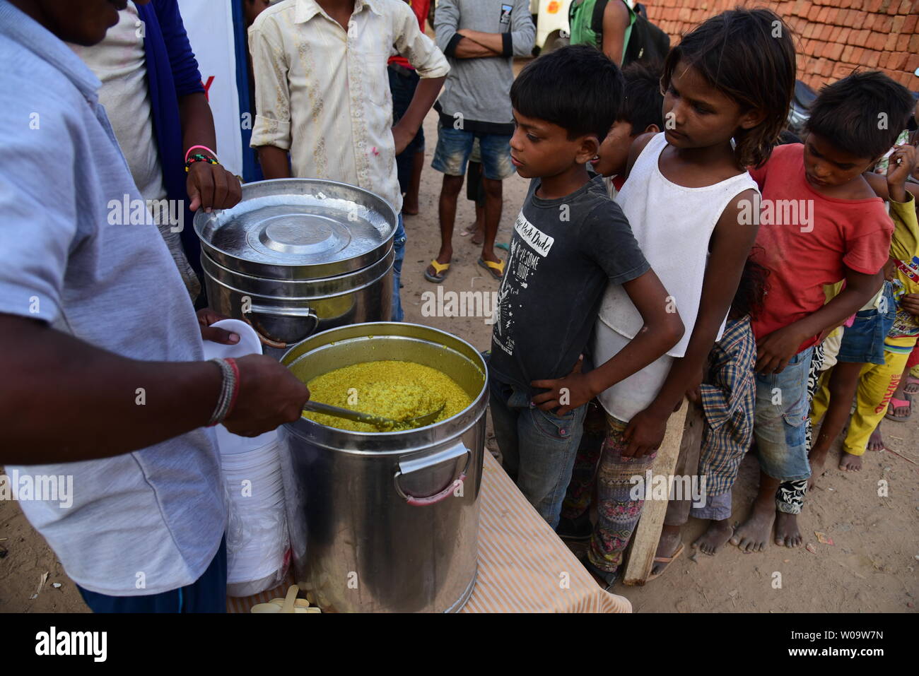 Poor children at a food distribution camp in New Delhi, India. Stock Photo