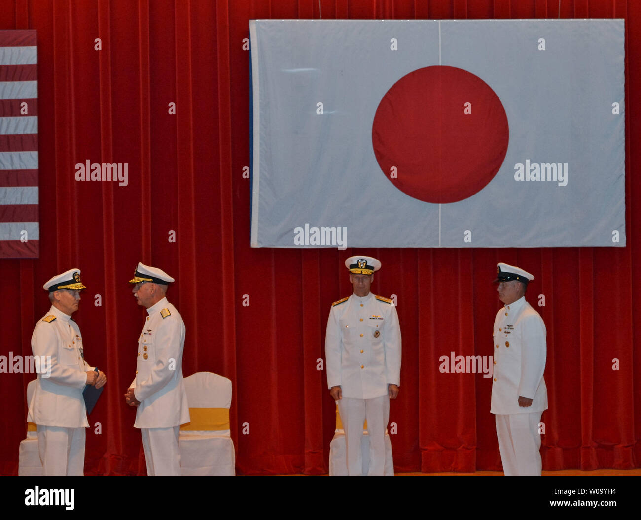 Vice Adm. Robert L. Thomas, commander of U.S. Seventh Fleet(L) speak with Adm. Scott H. Swift