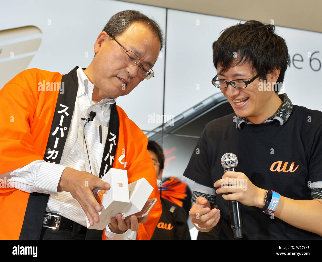 Koji Tanaka, President of KDDI Corporation speaks with first customer during launch day of new iPhone 6s and iPhone 6s Plus at the KDDI's au Shinjuku store in Tokyo, Japan, on September 25, 2015.     Photo by Keizo Mori/UPI Stock Photo