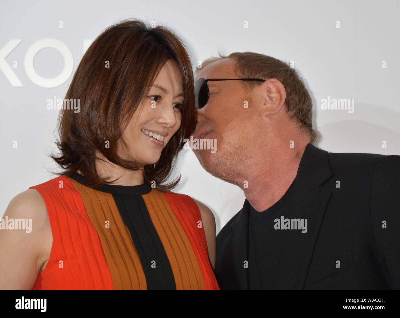 Fashion designer Michael Kors(R) and Japanese actress Ryoko Yonekura attend a photocall during the opening ceremony for flagship store of Michael Kors in Tokyo, Japan on November 20, 2015.     Photo by Keizo Mori/UPI Stock Photo