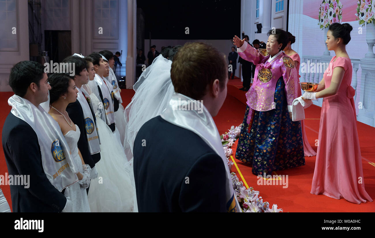 Hak Ja Han, wife of late Unification Church founder Sun Myung Moon sprinkles the holy water onto newly married couples during a Blessing Ceremony of the Family Federation for World Peace and Unification at the CheongShim Peace World Center in Gapyeong, South Korea, on February 20, 2016.     Photo by keizo Mori Stock Photo