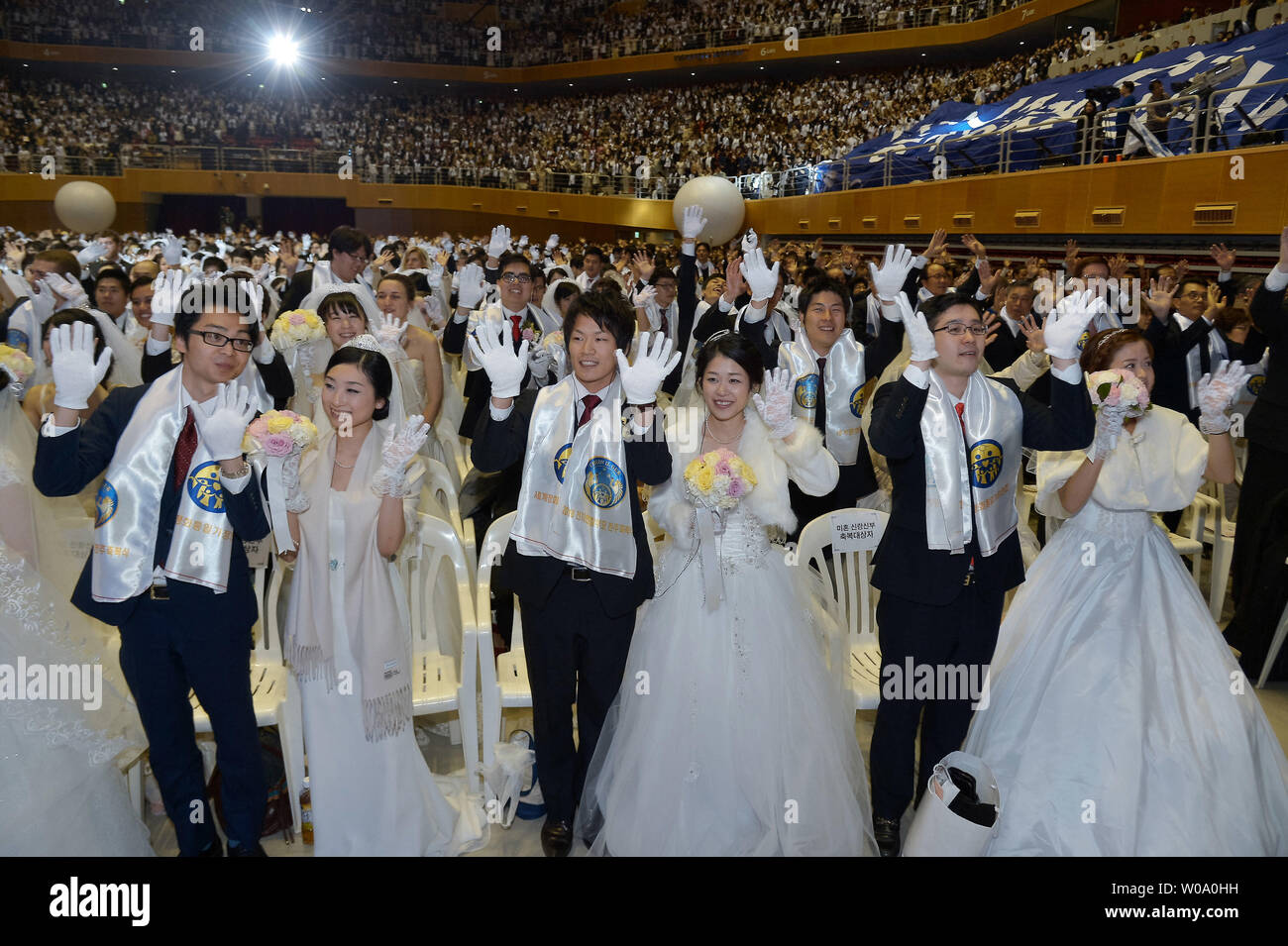 Newly married couples celebrate during a Blessing Ceremony of the Family  Federation for World Peace and Unification at the CheongShim Peace World  Center in Gapyeong, South Korea, on February 20, 2016. Photo