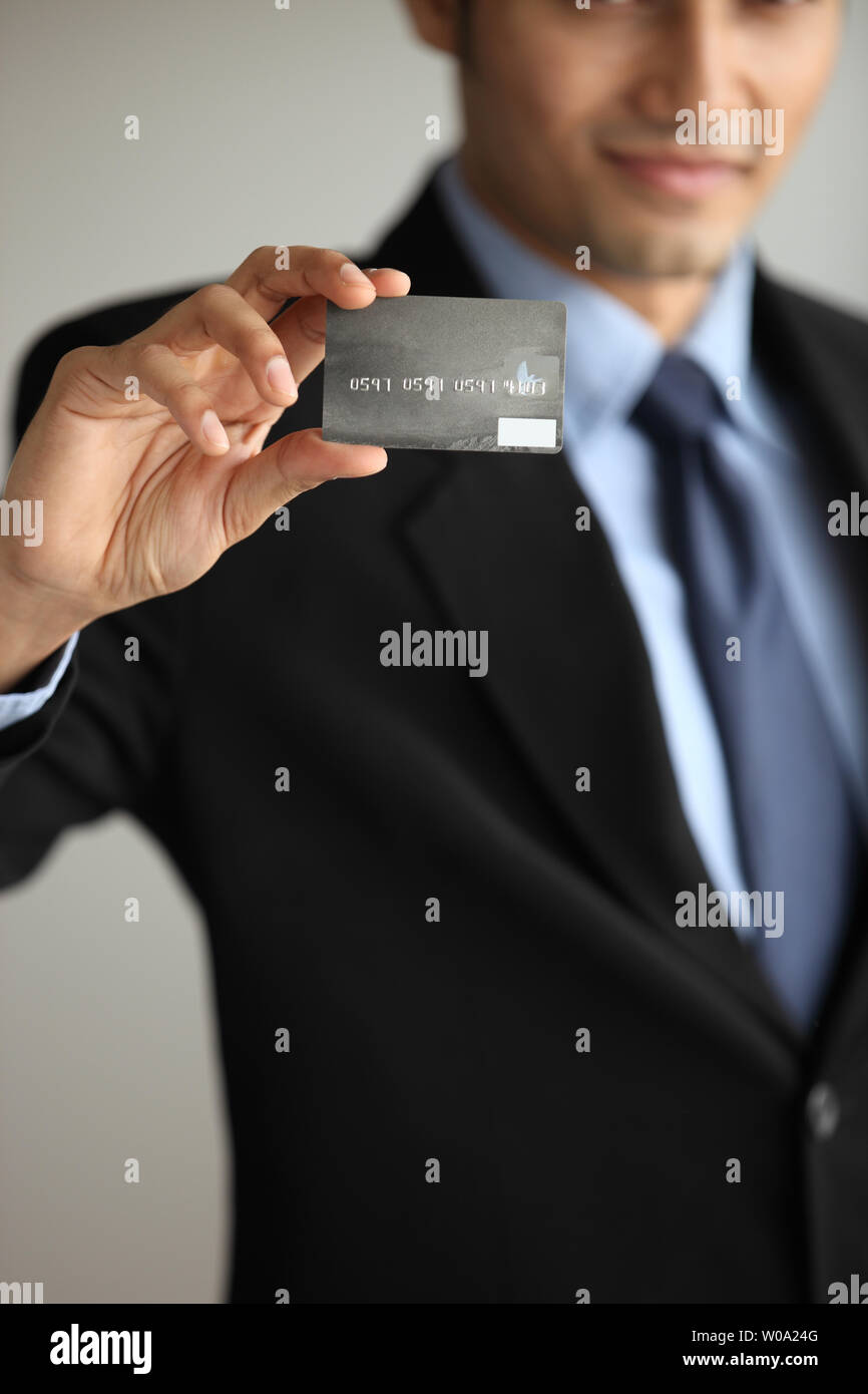 Indian businessman showing a credit card Stock Photo - Alamy