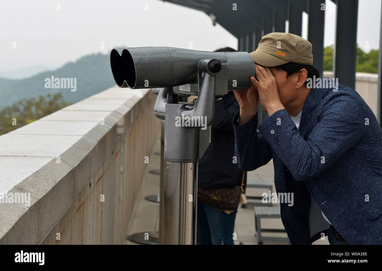 A tourists use binoculars to see North Korea at the Odusan Unification