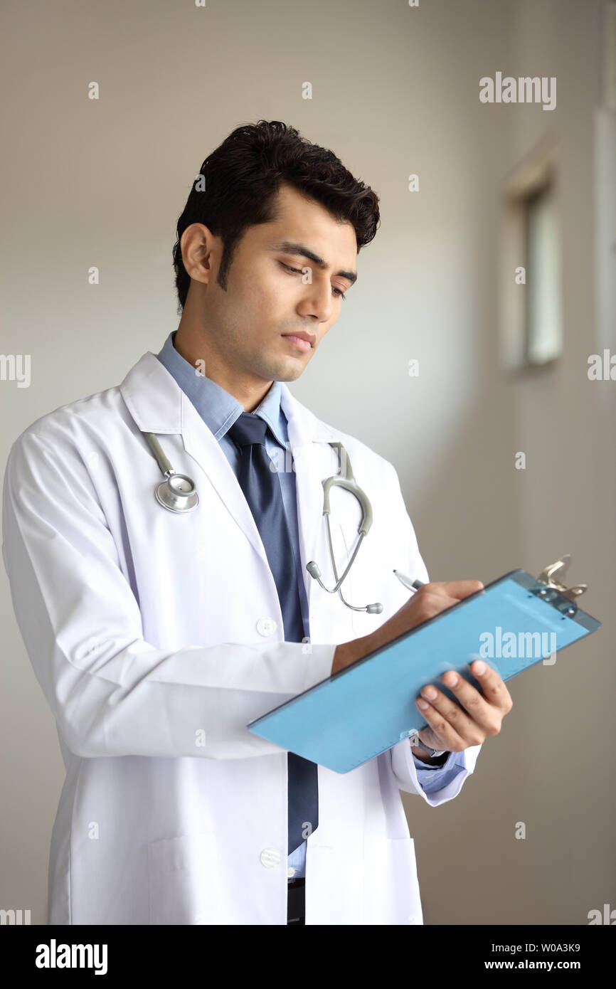 Indian male doctor clipboard hi-res stock photography and images - Alamy