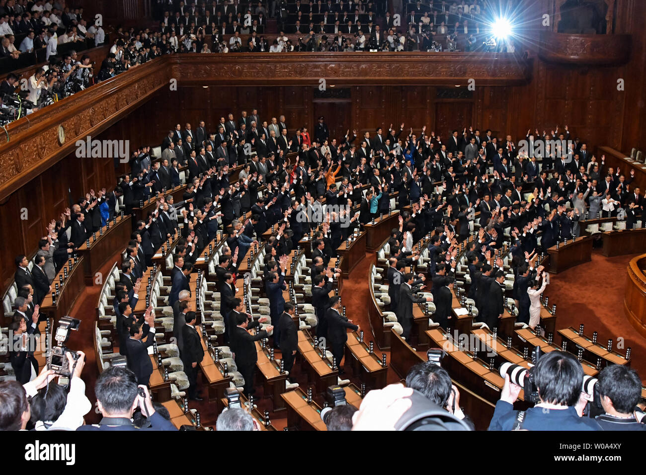 Japanese lawmakers raise their hands and shouts 'Banzai' at the plenary Diet session of the House of Representatives in Tokyo, Japan on September 28, 2017.     Photo by Keizo Mori/UPI Stock Photo