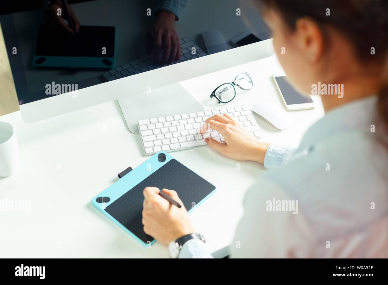 Young female designer using graphics tablet Stock Photo