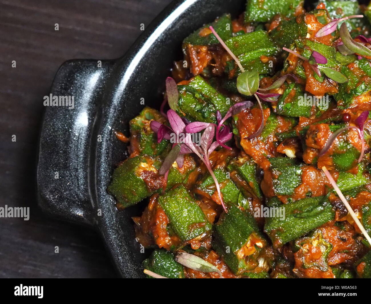 June 2019 - Close Up Of A Plate Of Spicy Baby Okra Curry From A Michelin Starred Restaurant Stock Photo