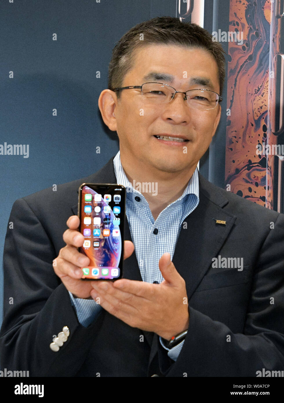 Makoto Takahashi, President of KDDI Corporation poses for camera during launch event for Apple New iPhone Xs and Xs Max at the KDDI's au Shinjuku store in Tokyo, Japan, on September 21, 2018.     Photo by Keizo Mori/UPI Stock Photo