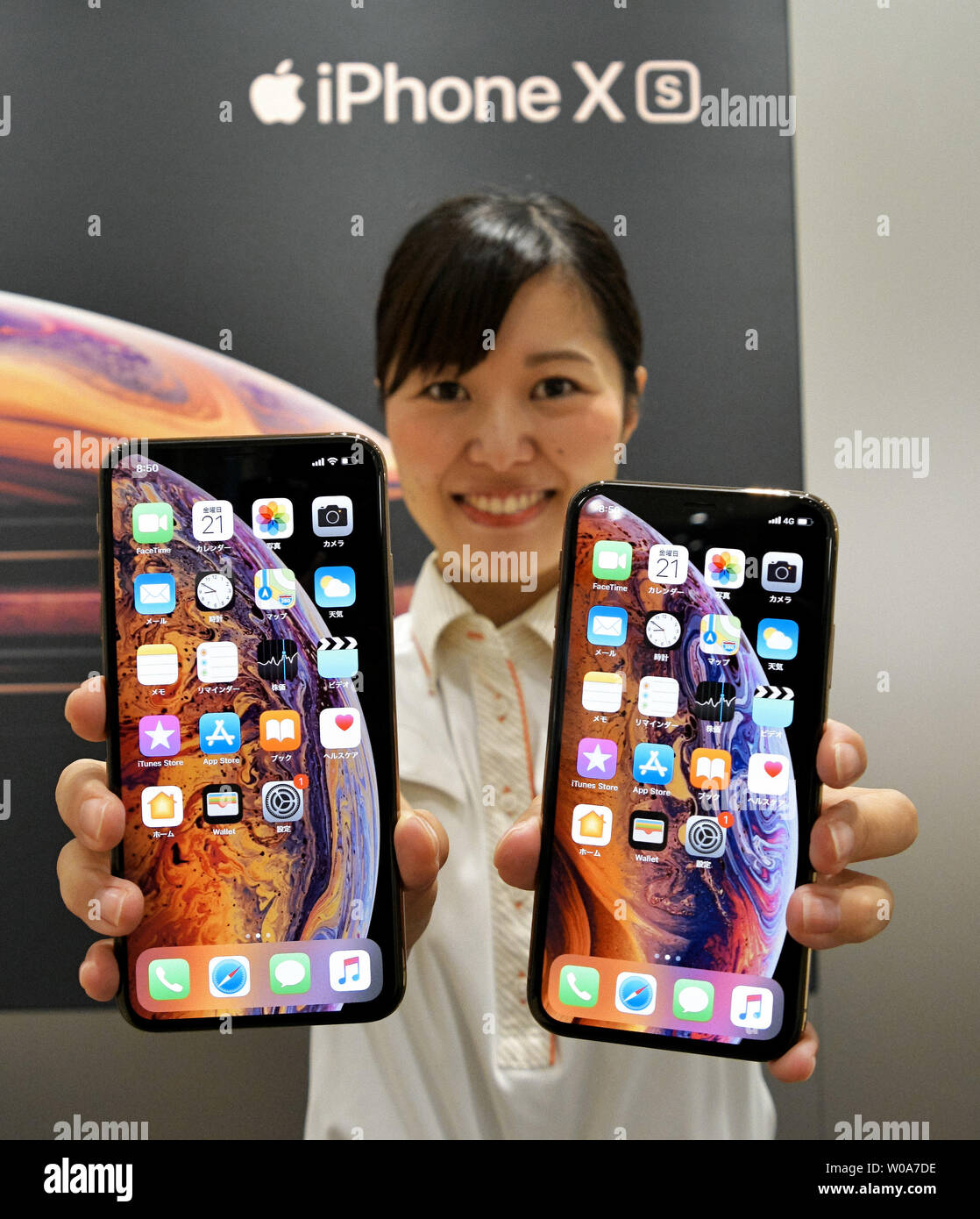 A Model poses for camera during a launch day for Apple New iPhone Xs and Xs  Max at the KDDI's au Shinjuku store in Tokyo, Japan, on September 21, 2018.  Photo by
