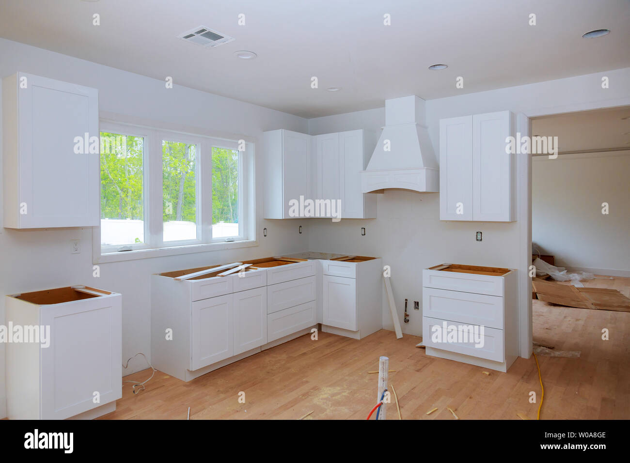 Interior design construction of kitchen with cabinet maker installing custom Stock Photo