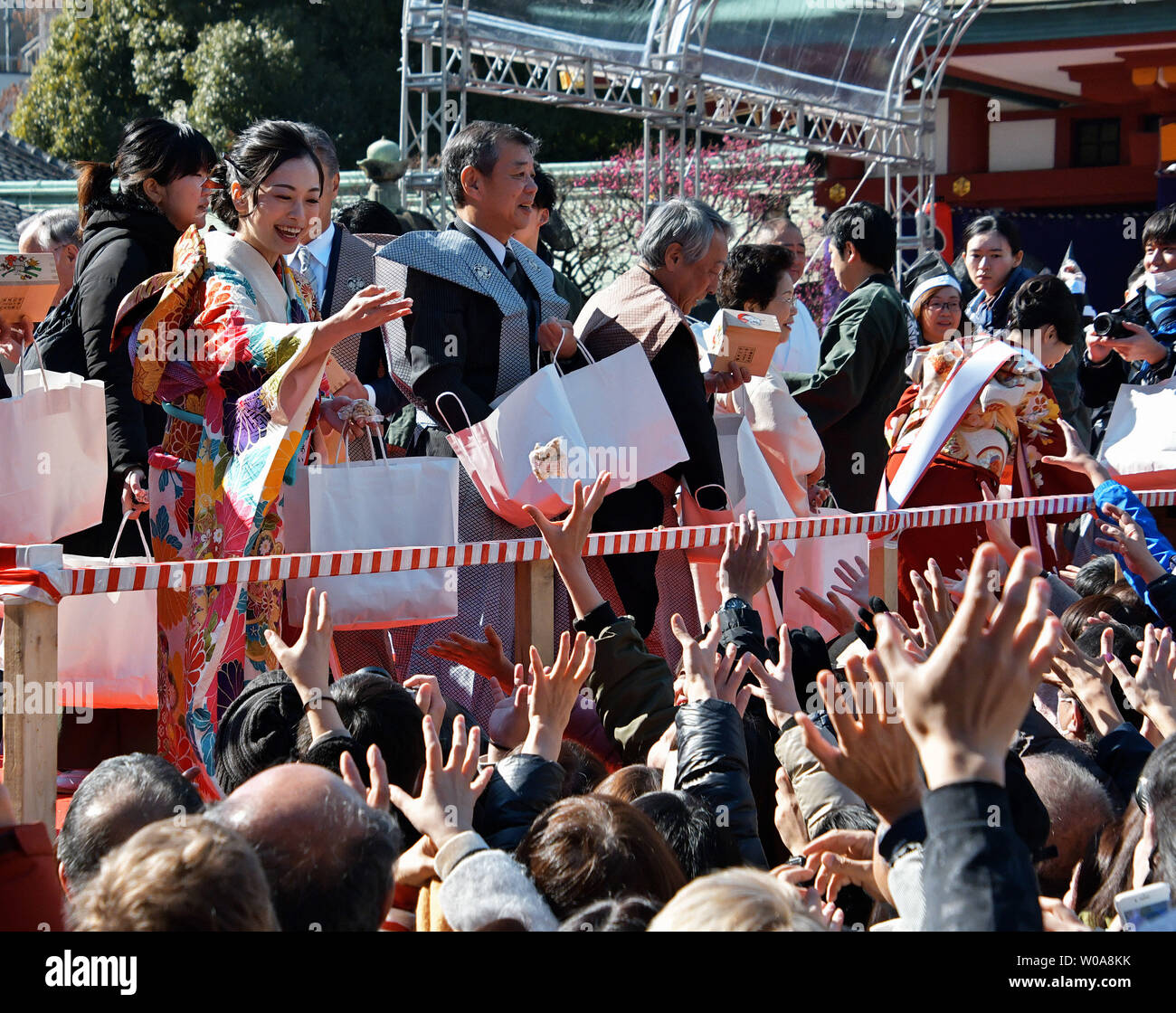 local celebrities throw beans during the beanthrowing ceremony at Hie