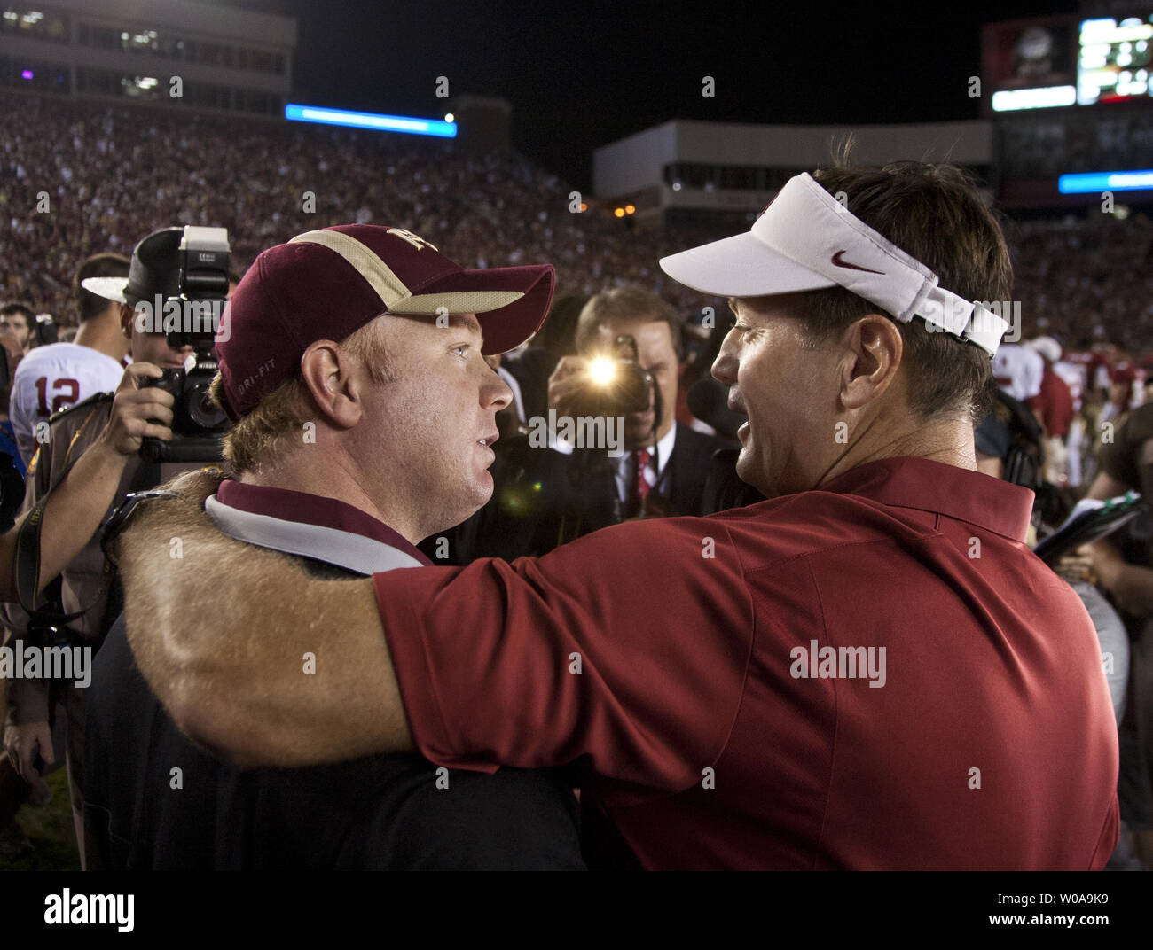 Florida State defensive coordinator Mark Stoops (L) congratulates his brother,  Oklahoma head coach Bob Stoops after the Oklahoma Sooners defeated the Florida State Seminoles 23-13 in  their NCAA football game in Tallahassee, Florida Sept 17, 2011.    UPI/Mark Wallheiser Stock Photo