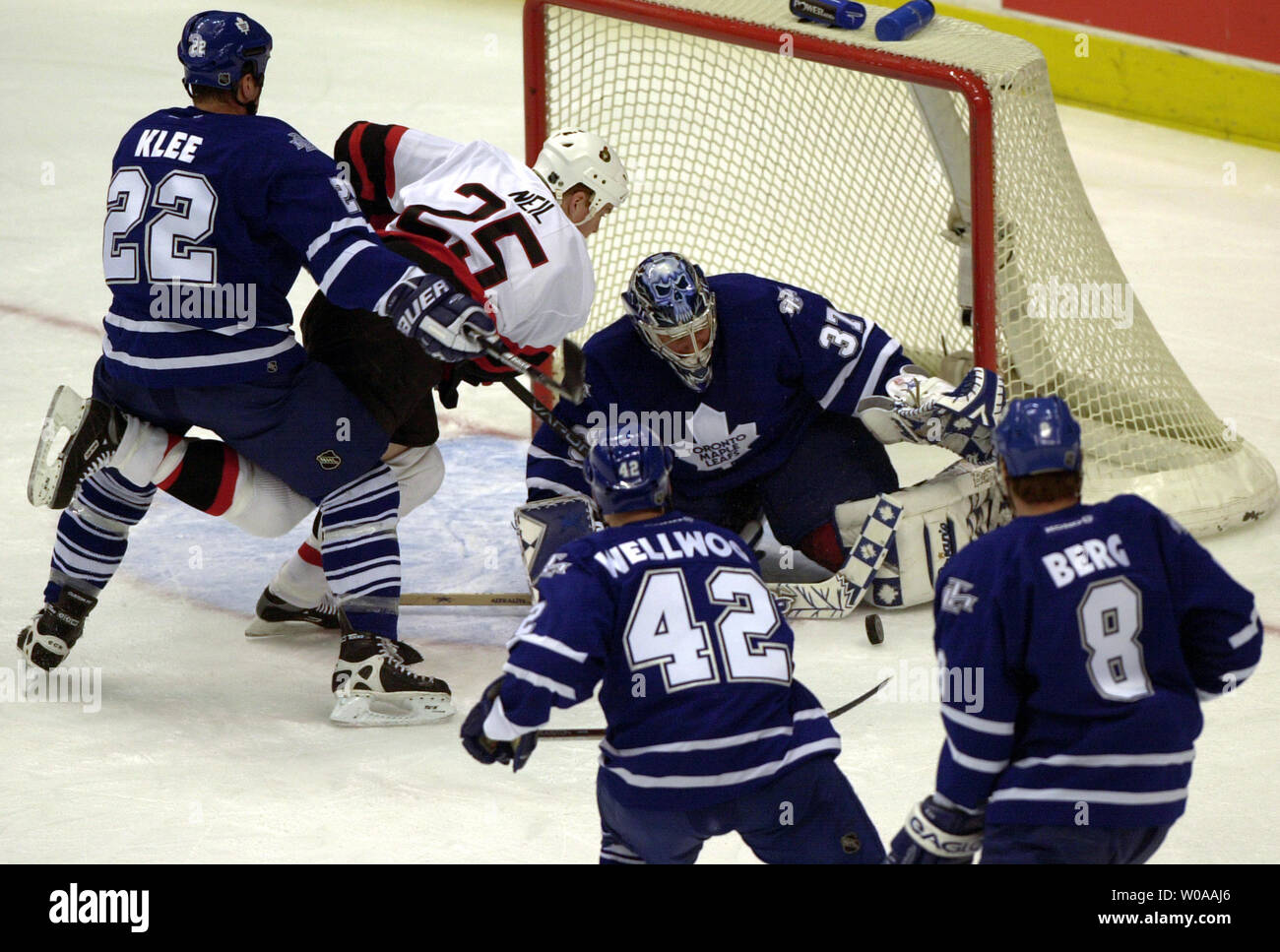 Ottawa Senators' Chris Neil attempts a shot on goal surrounded by Toronto Maple Leafs' Ken Klee, Kyle Wellwood, Aki Berg and goailie Trevor Kidd in first period action at the Air Canada Center in Toronto, Canada on Jan. 8, 2004. (UPI Photo/Christine Chew) Stock Photo