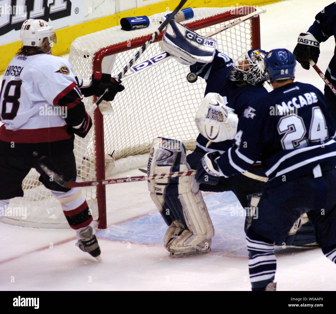 Toronto Maple Leafs' goalie Ed Belfour makes a save off a shot by Ottawa Senators' Marian Hossa(no. 18) during second period action in Game 7 of their series in the first round of the NHL playoffs at the Air Canada Center in Toronto, Canada on Apr. 20, 2004. Belfour made 36 saves in the game and was the man of the match as the Leafs defeated the Senators 4-1 to advance to the next round. (UPI Photo/Christine Chew) Stock Photo
