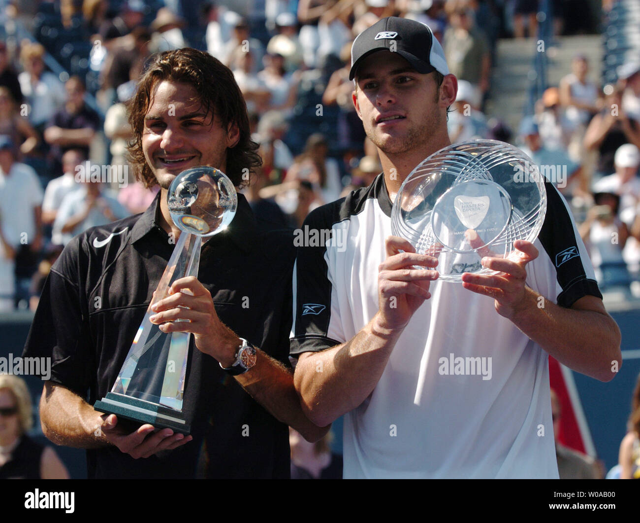 Top seed Roger Federer of Switzerland and Andy Roddick pose with their  trophies after the Tennis Masters Canada singles final at the Rexall Center  August 1, 2004 in Toronto, Canada. Federer won