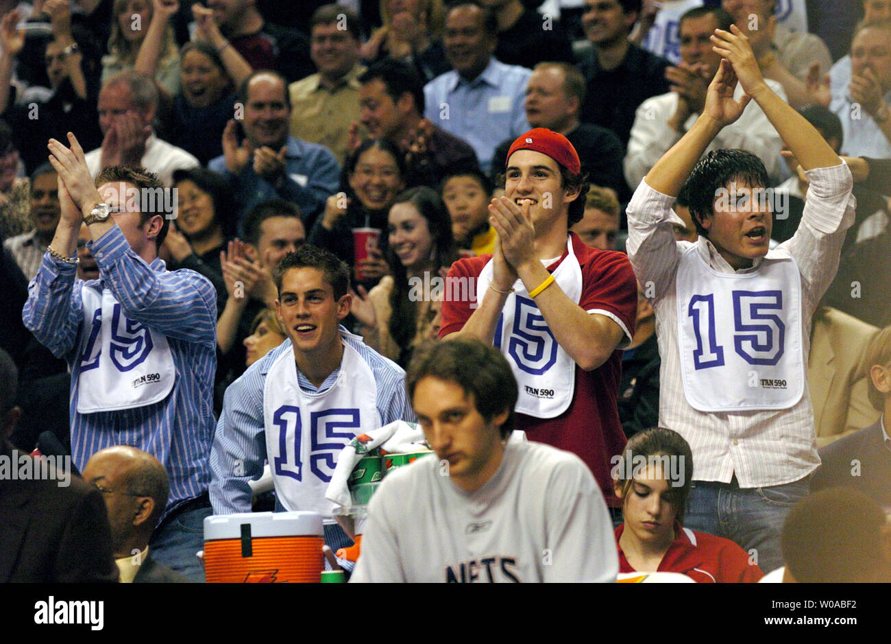 Fans wearing babies' bibs with New Jersey Nets' Vince Carter's number heckled their former hero throughout the game as the Toronto Raptors hosted the Nets at the Air Canada Center April 15, 2005 in Toronto, Canada. Carter who had a reputation as a mama's boy  and crybaby among fans here scored 39 points as he led the Nets to a 101-90 win over his former team in his first appearance back in Toronto after being traded. (UPI Photo/Christine Chew) Stock Photo
