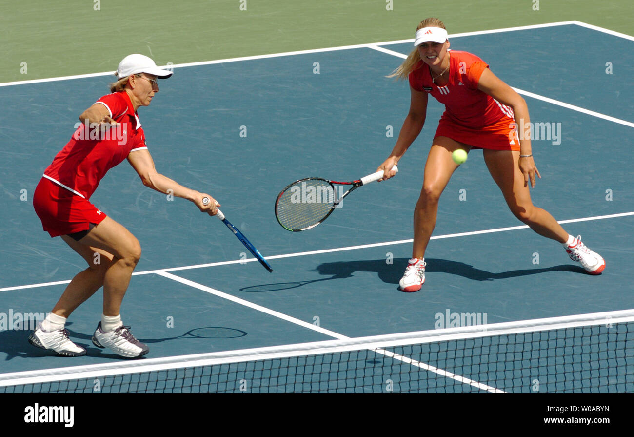 Tennis legend Martina Navratilova(left) and Anna-Lena Groenefeld converge on the ball during the doubles final against Conchita Martinez and Virginia Ruano Pascual at the Rogers Cup tournament at the Rexall Center August 21, 2005 in Toronto, Canada. Navratilova and Groenefeld rallied from a set down to win the match 5-7, 6-3, 6-4 and take the doubles trophy. (UPI Photo/Christine Chew) Stock Photo