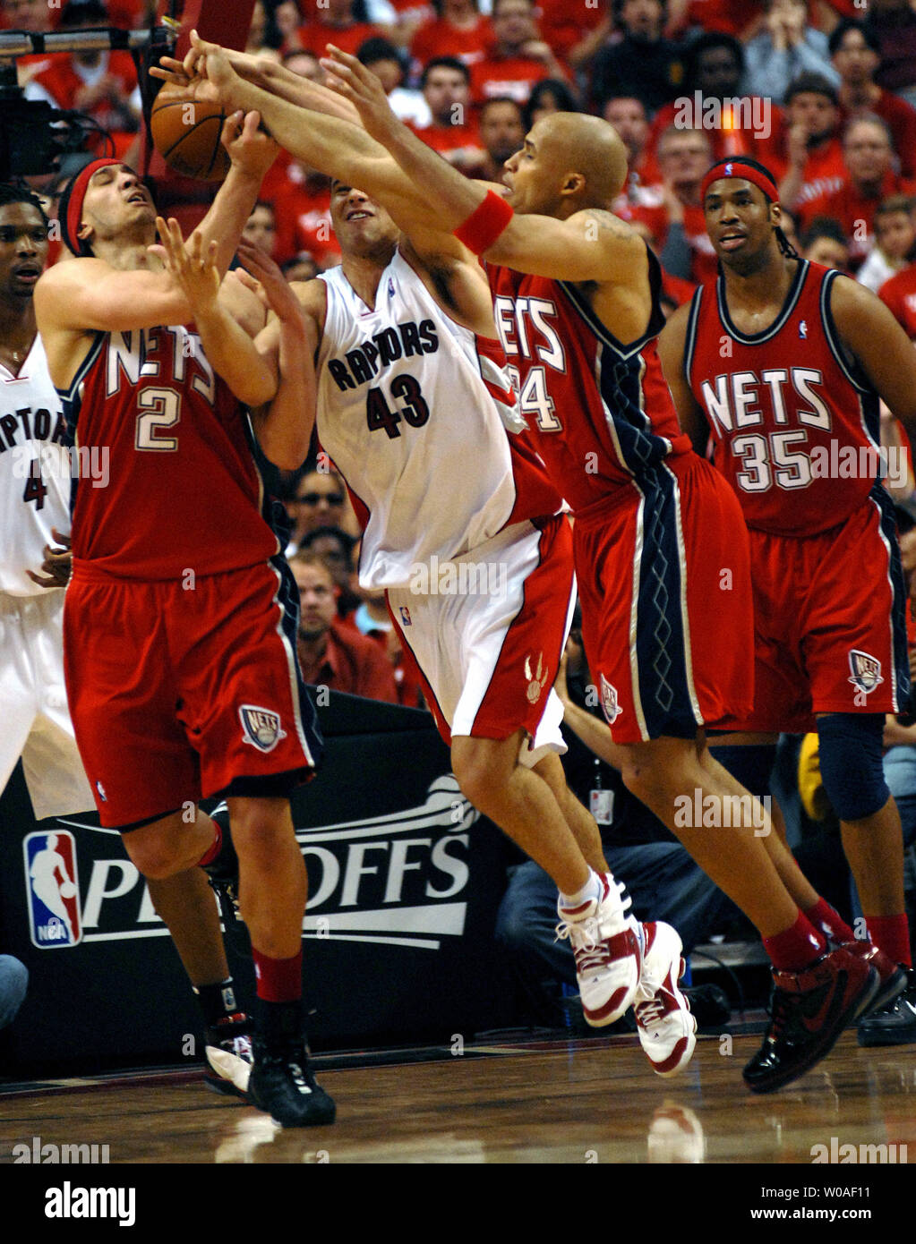 New Jersey Nets' Josh Boone (L), Toronto Raptors' Kris Humphries (C) and  Nets' Richard Jefferson battle for a loose ball during third quarter action at  the Air Canada Center in Toronto, Canada