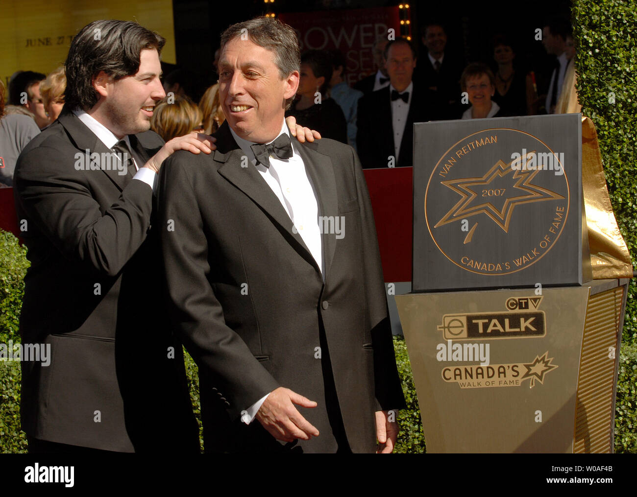 Director Ivan Reitman (R) gets congratulations from his son Jason as he ...