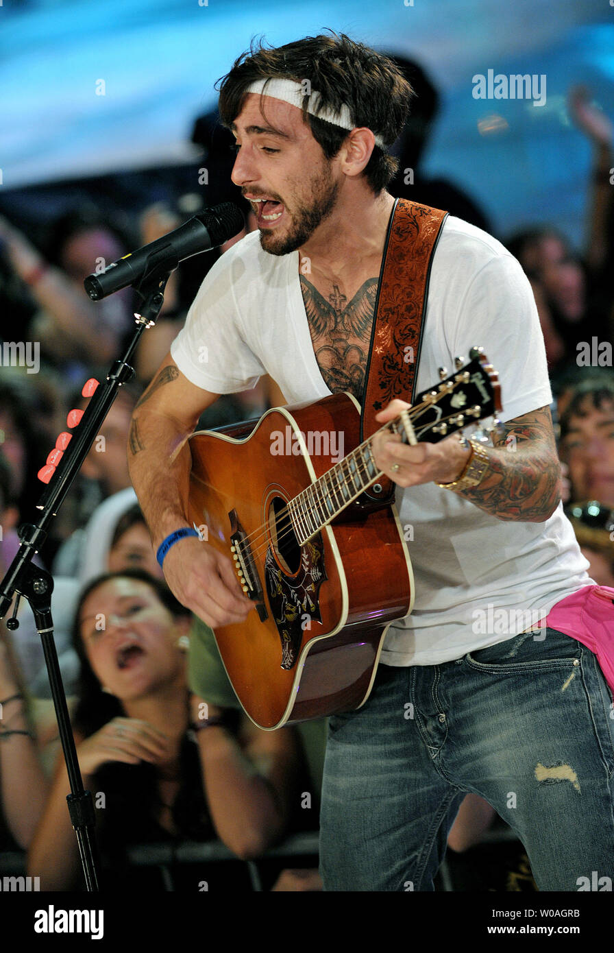 Lead singer Jacob Hoggard of Hedley performs on an outdoor stage before