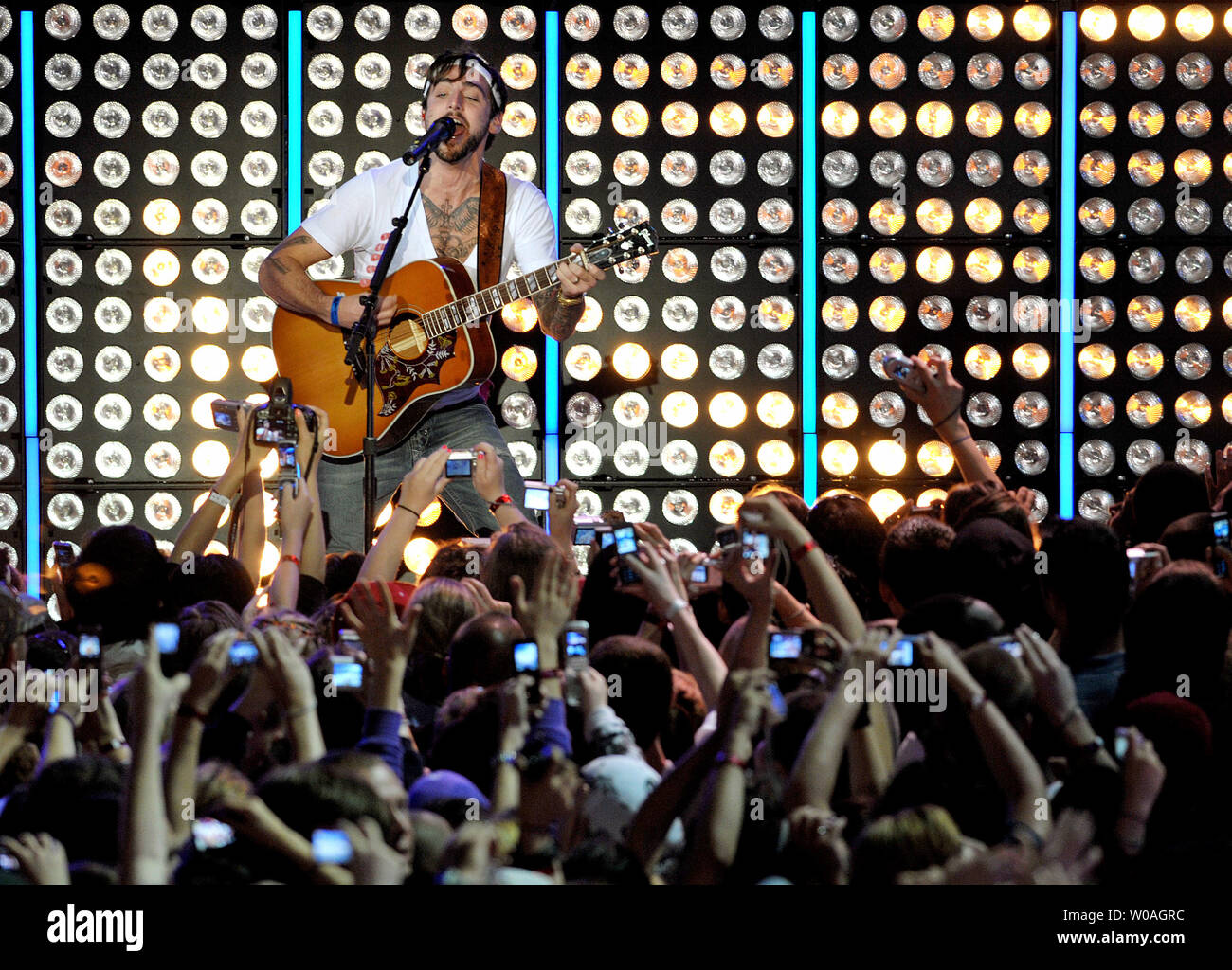 Lead singer Jacob Hoggard of Hedley performs on an outdoor stage before